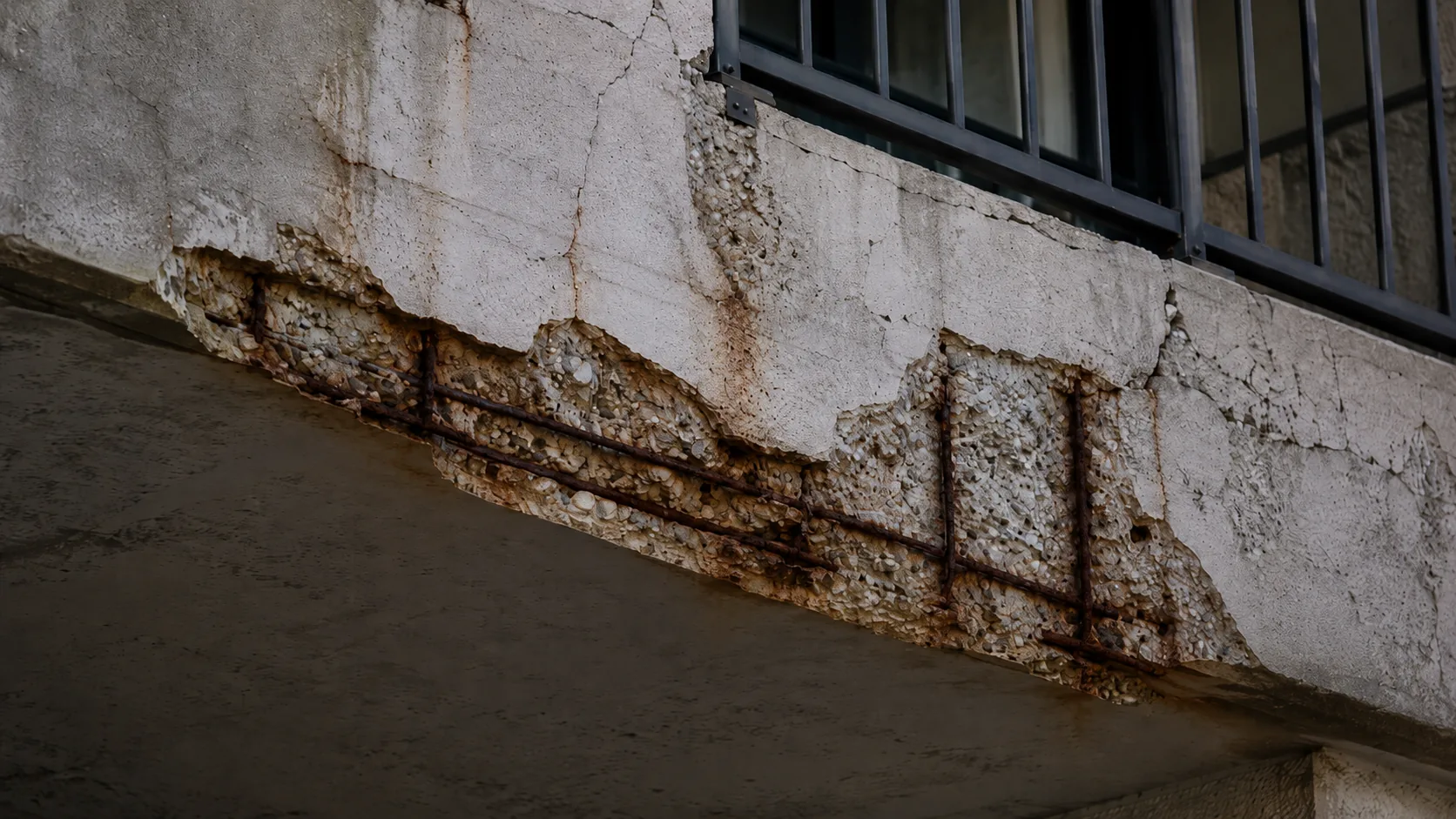 Concrete balcony spalling with exposed reinforcing steel